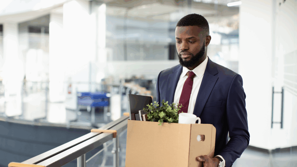 Man carrying a box after losing his job